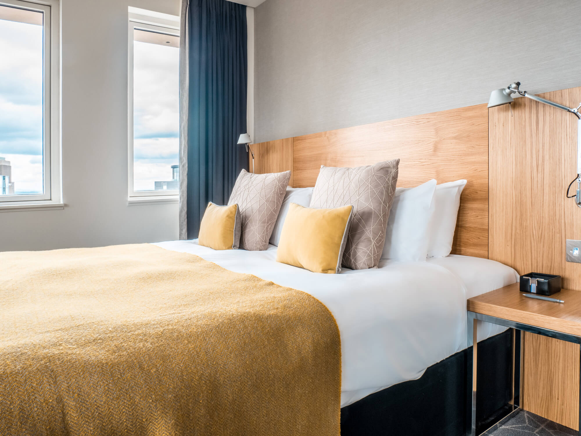 Deluxe Room with king-size bed and sofa at Apex Waterloo Place Hotel