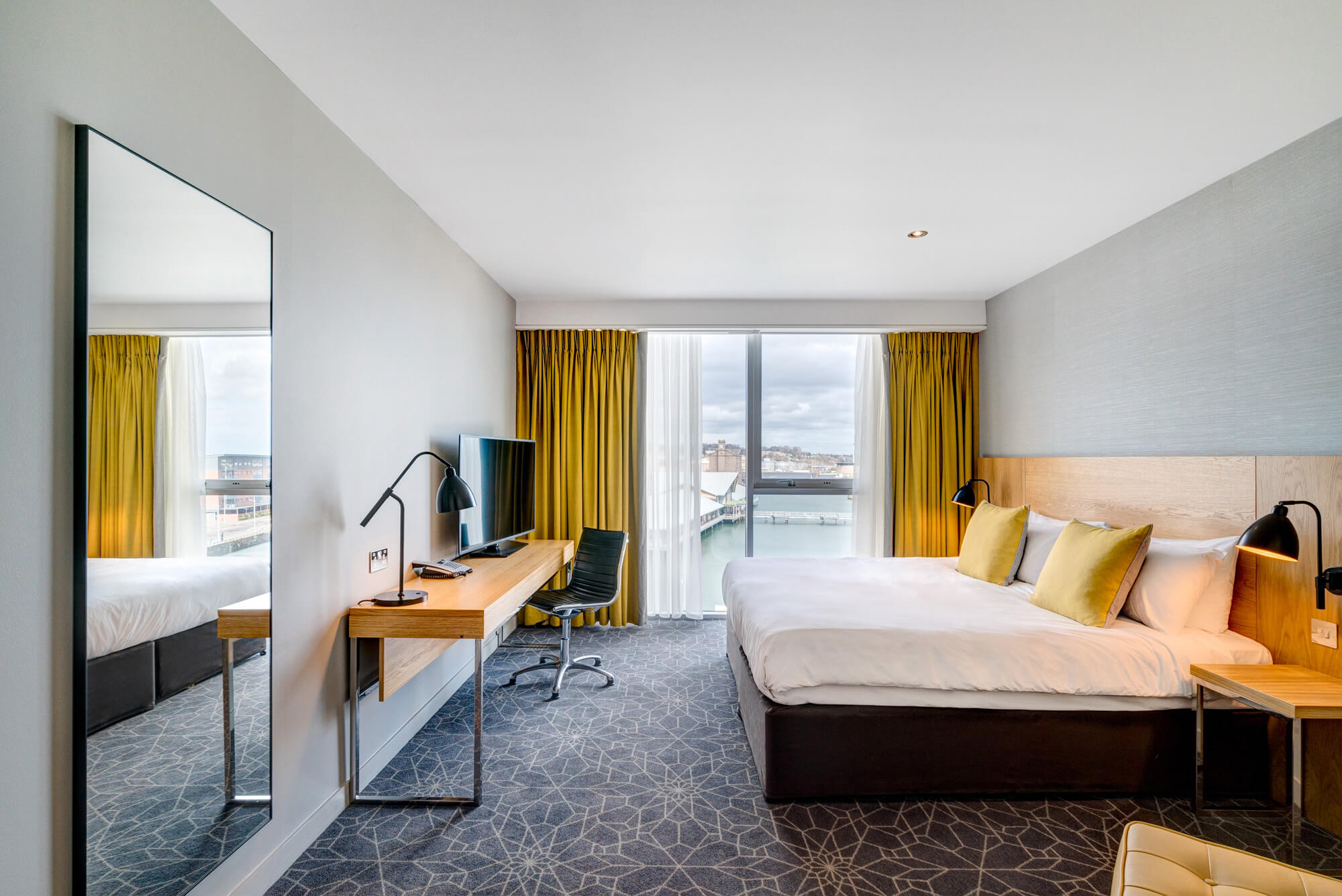 King-size bed with TV on desk and Quay Views