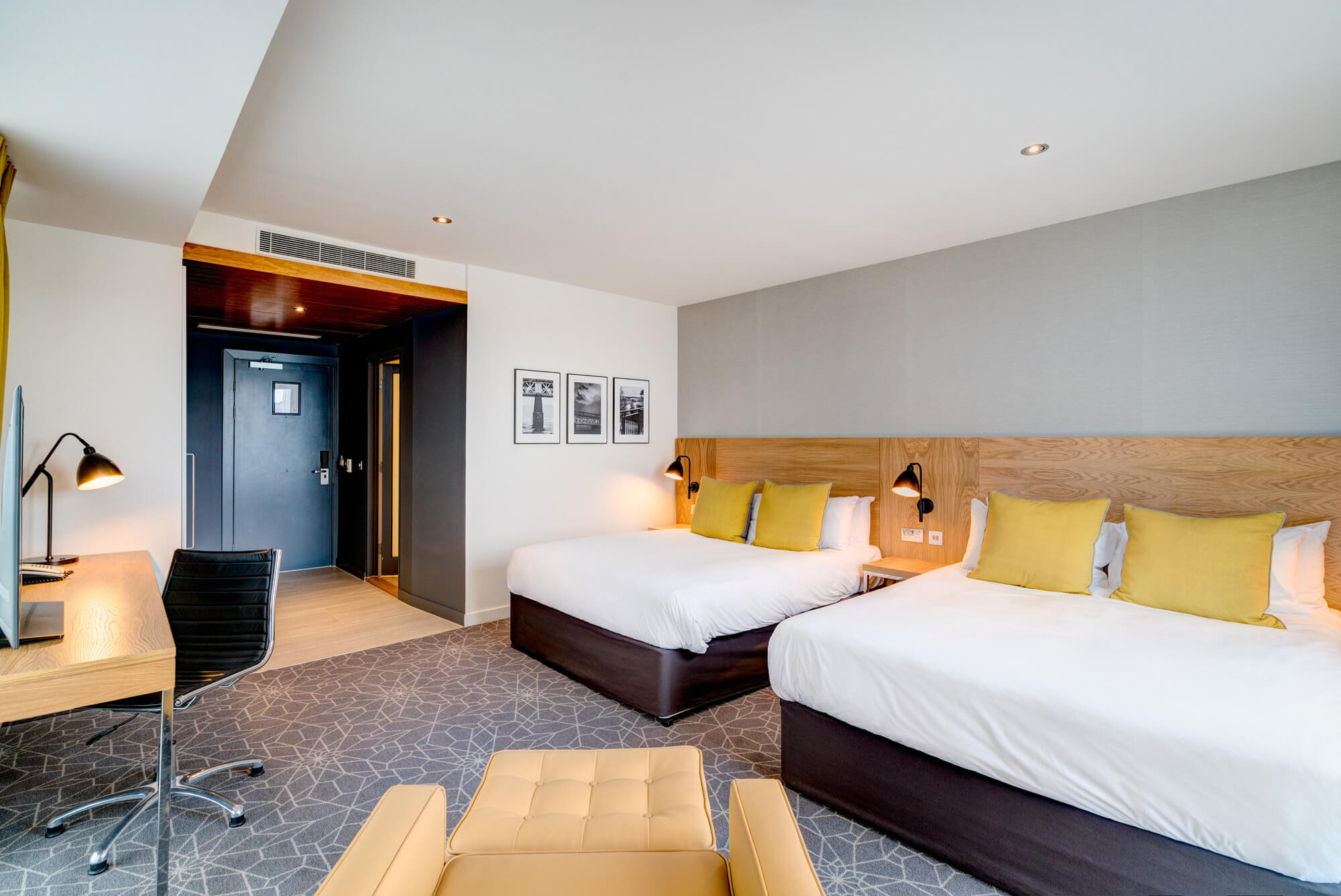 Family Room at Apex City Quay Hotel & Spa Family Room in Dundee with two beds, desk and armchair