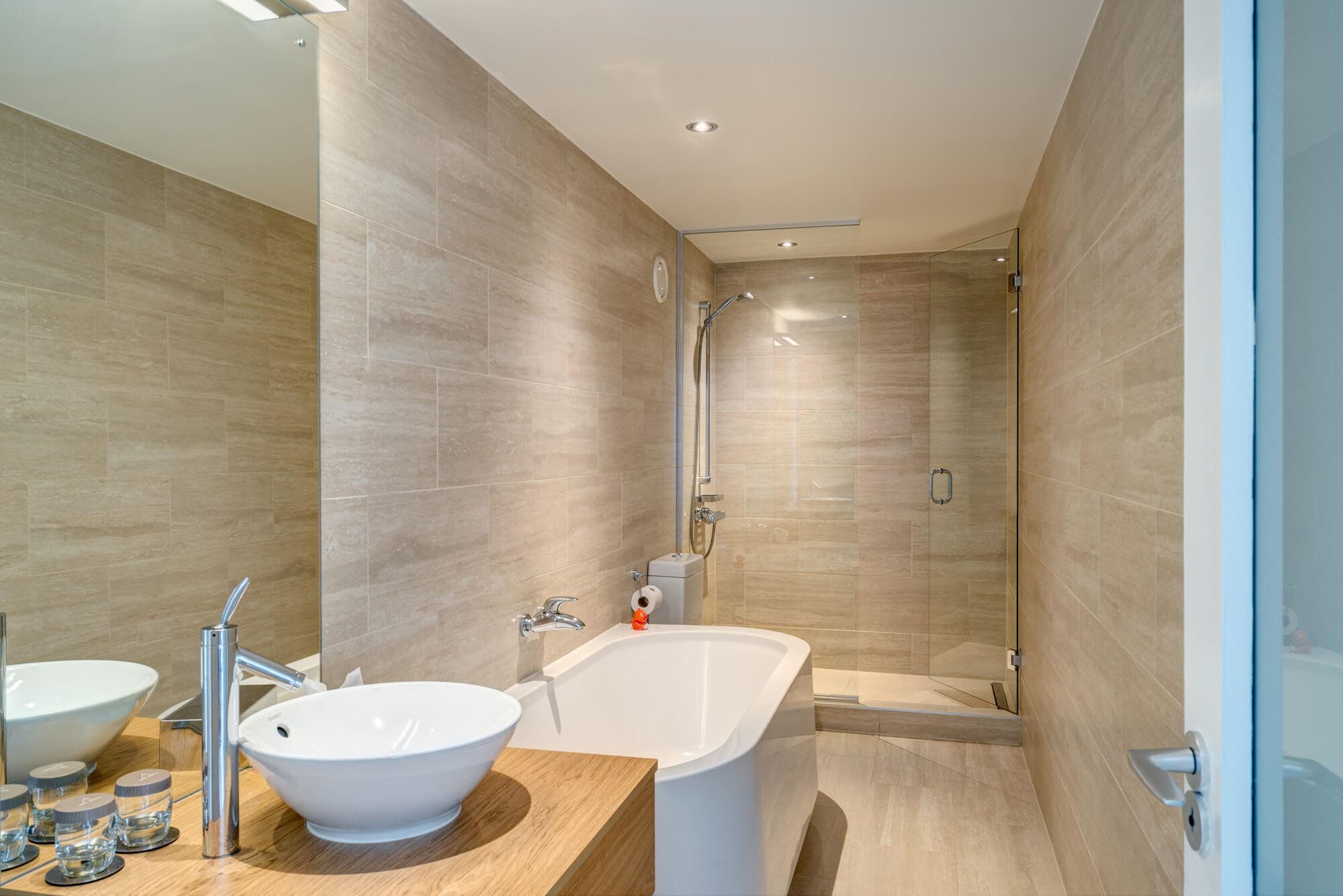 Junior Suite bathroom with tub and walk-in shower