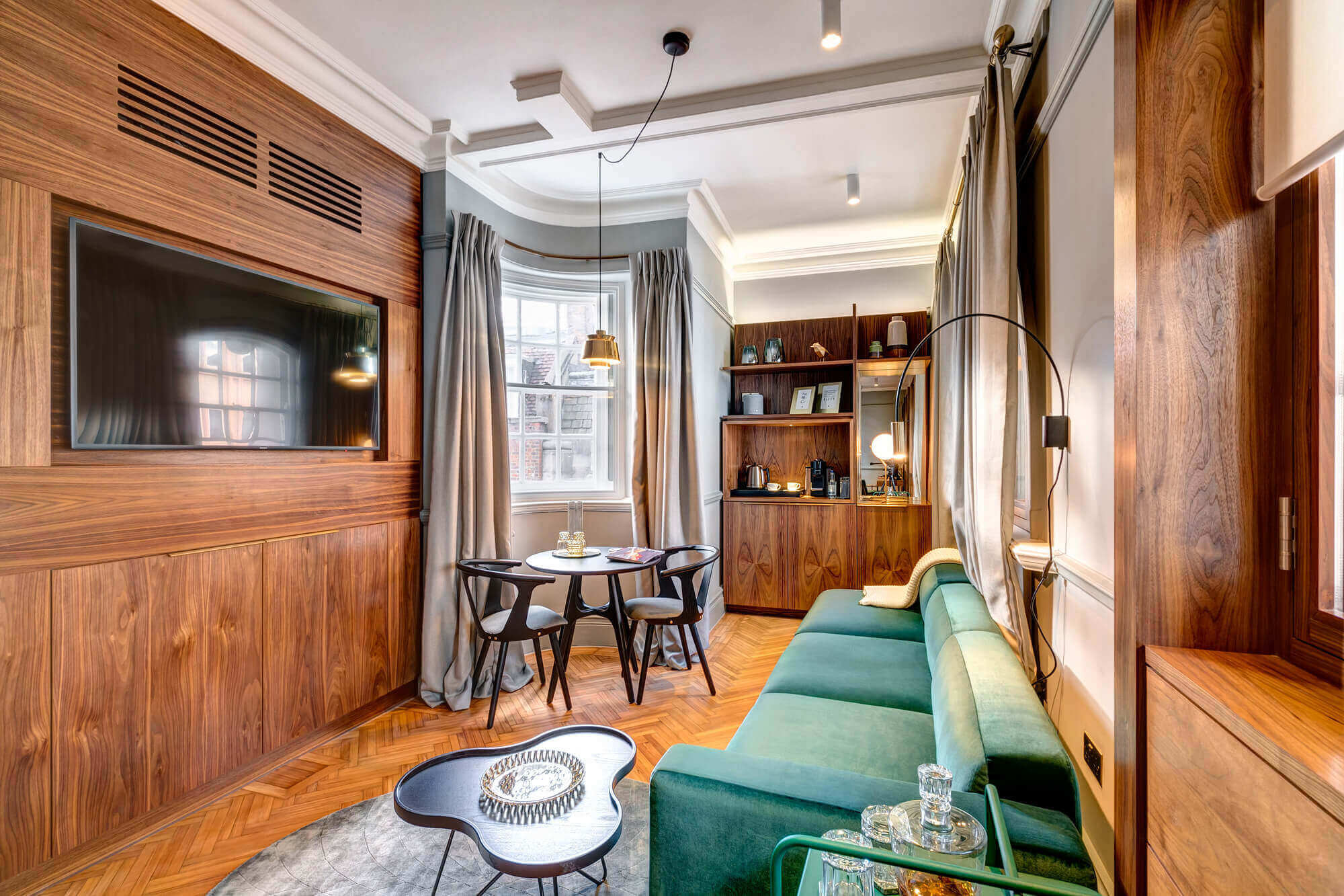 Grand Suite at Apex Temple Court Hotel Grand Suite living area with sofa, TV and table at Apex Temple Court Hotel