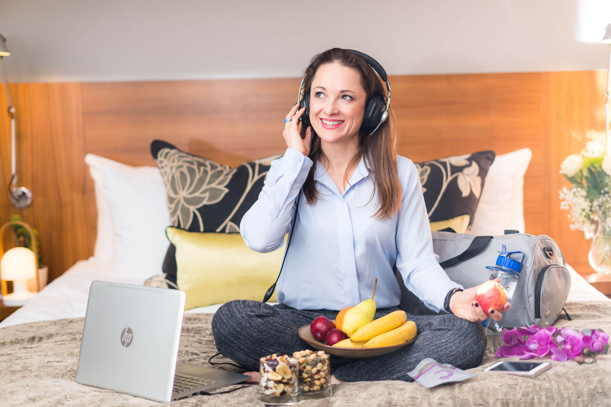 woman relaxing on her bed with her laptop