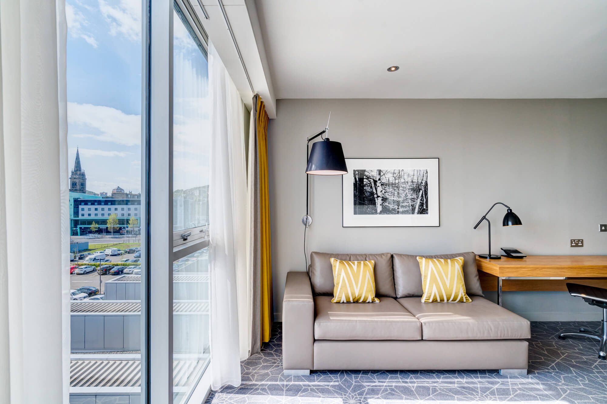 Junior Suite sofa and reading lamp next to window