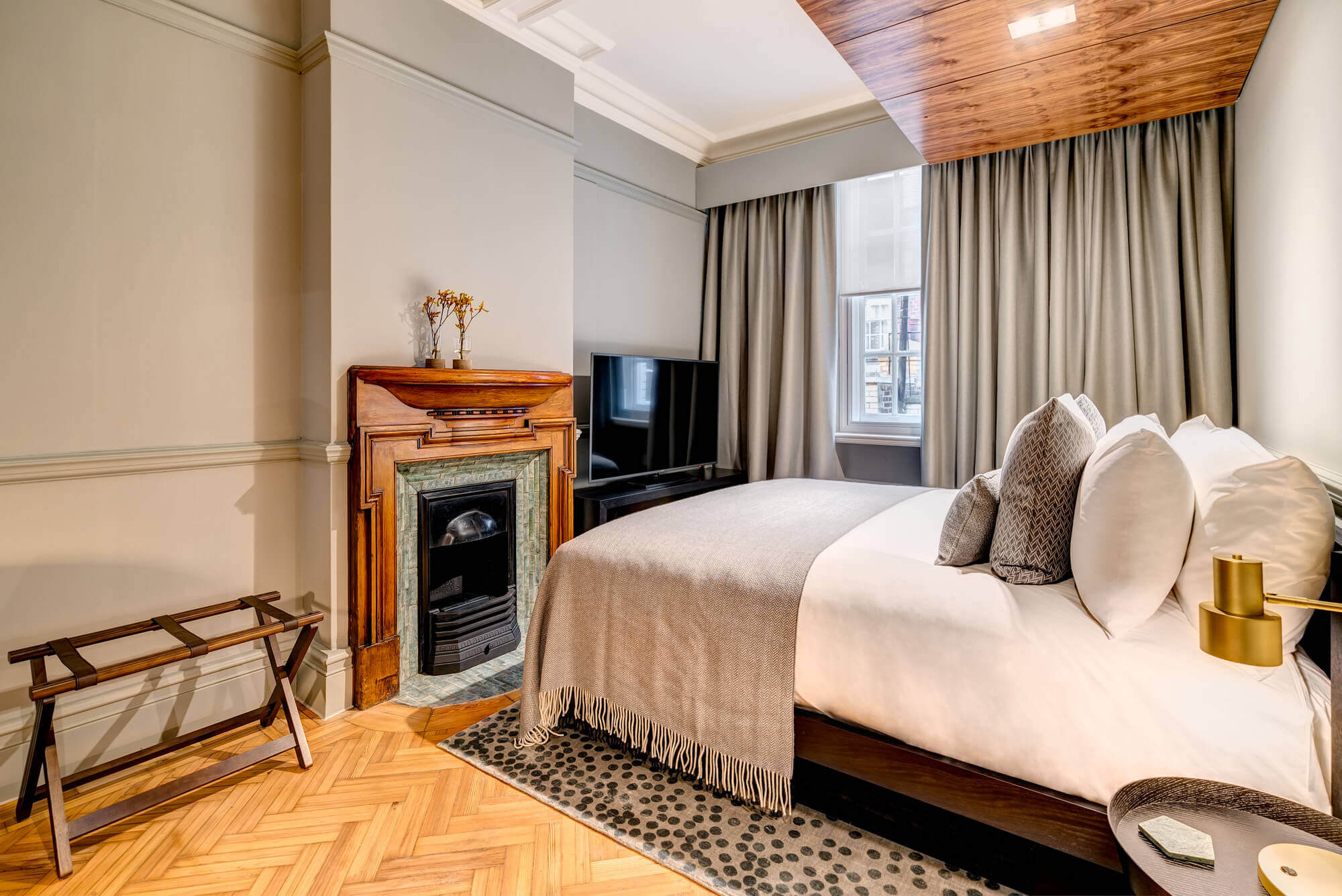 Grand Suite bedroom with fireplace at Apex Temple Court Hotel