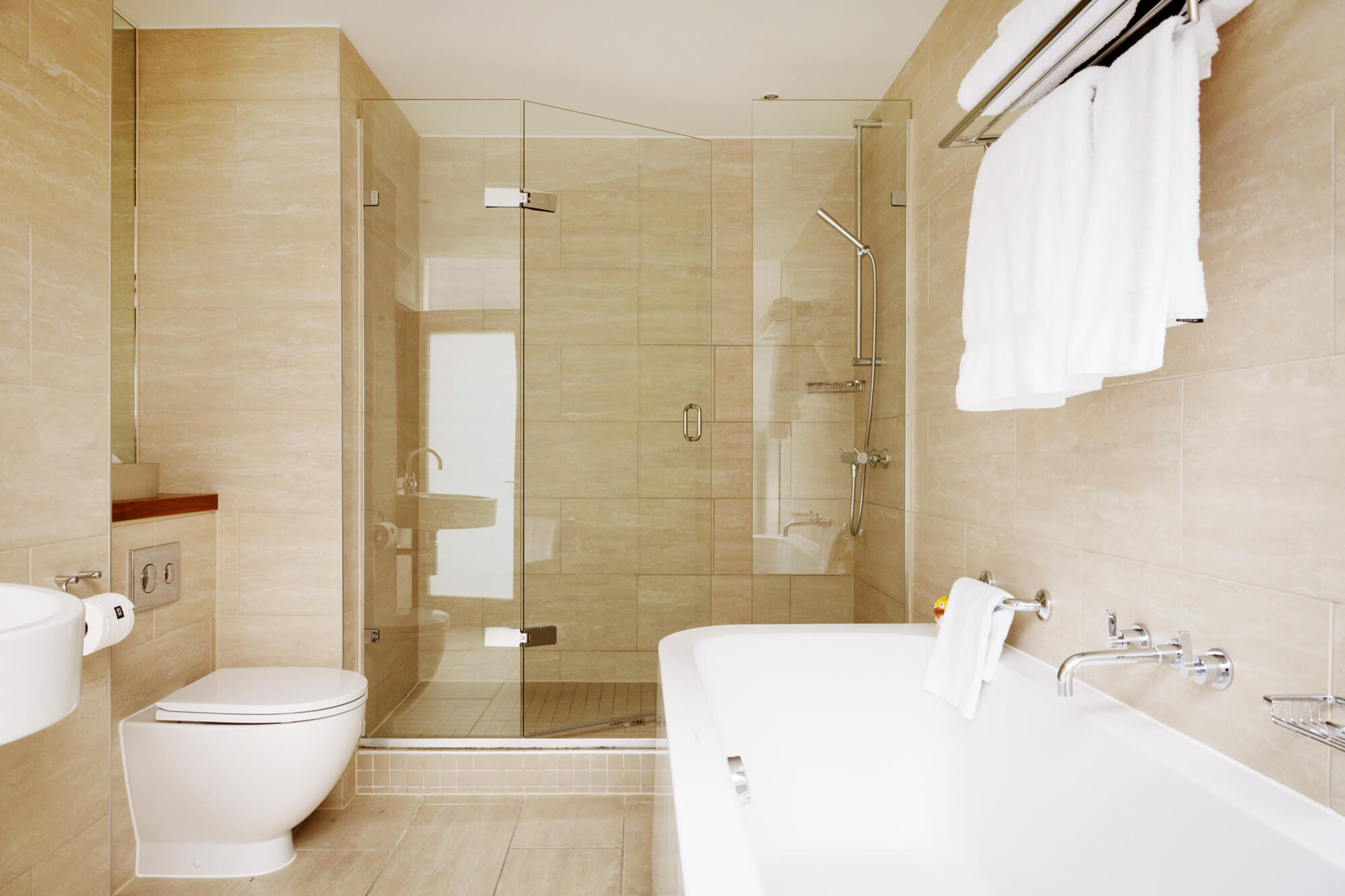 Superior Room bathroom with walk-in shower and free standing bath at Apex City of London Hotel