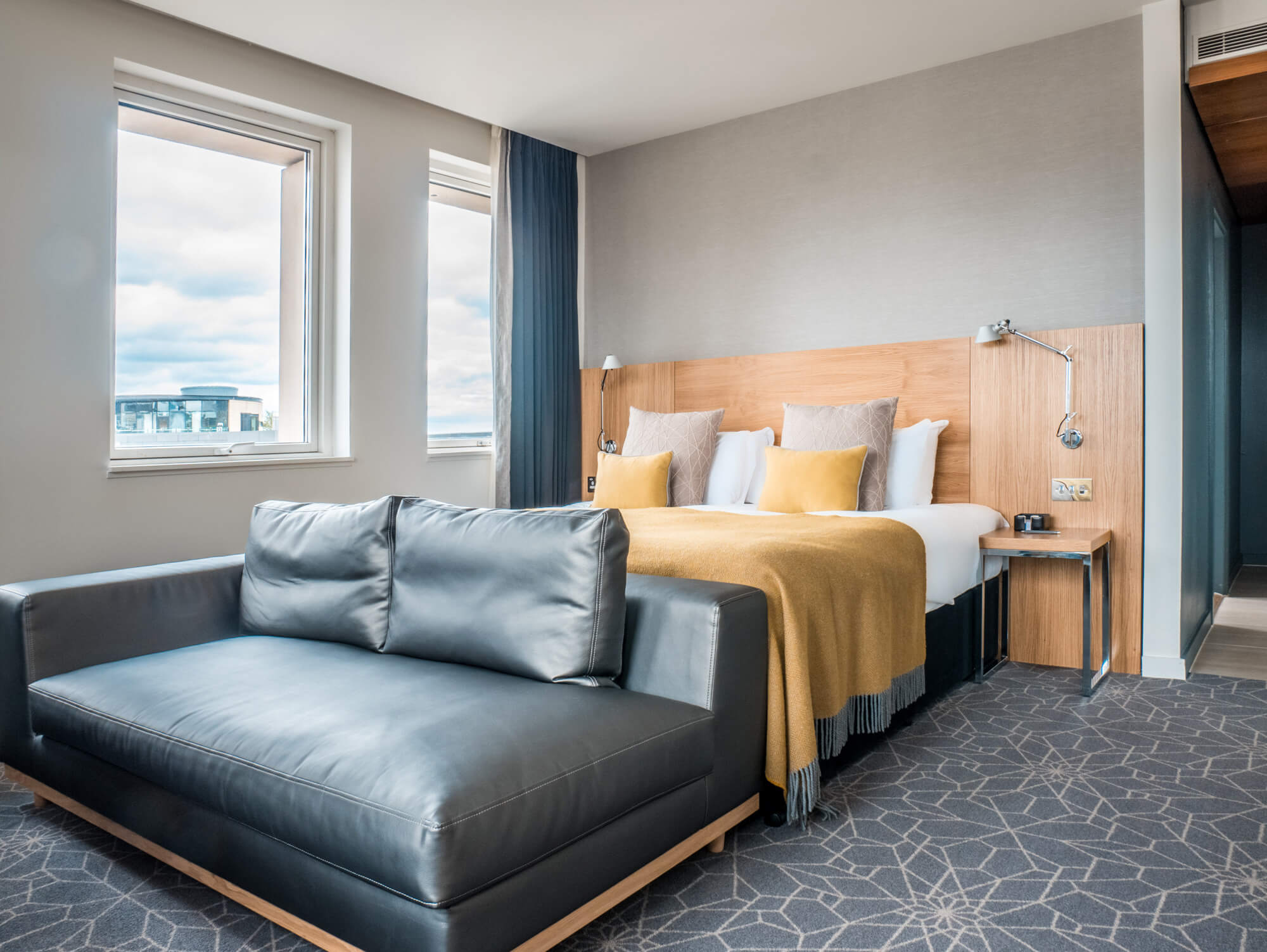 Deluxe Room at Apex Waterloo Place Hotel Deluxe Room with king-size bed and sofa at Apex Waterloo Place Hotel