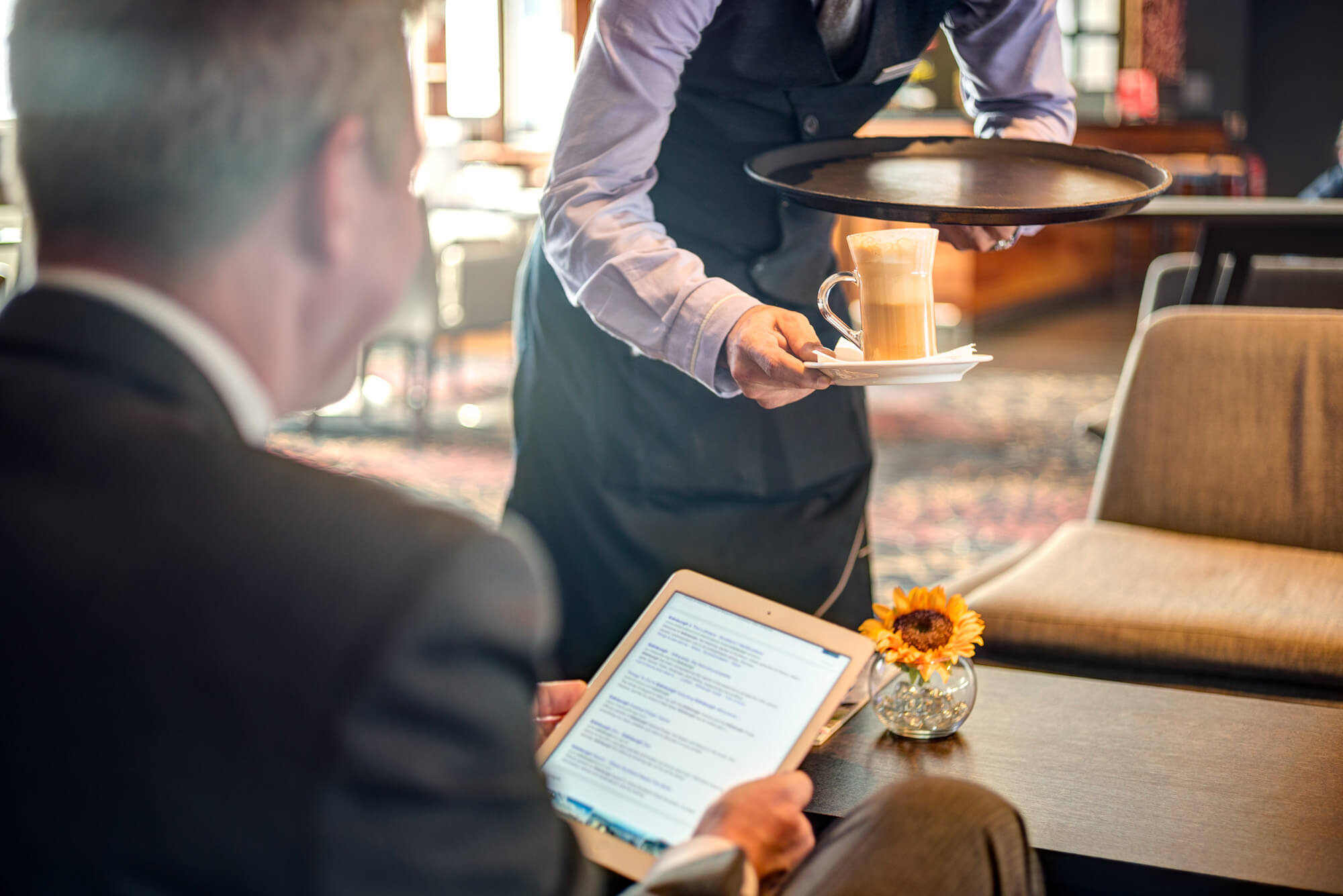Drinks at Apex Grassmarket Hotel Waiter serving guest coffee